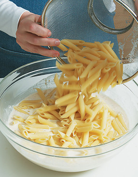 When adding cooked penne to the cheese mixture, stir well so the sauce fills the pasta tubes.