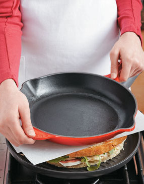 Flatten and crisp the panini by weighing it down with a skillet (if needed, add cans for more weight).