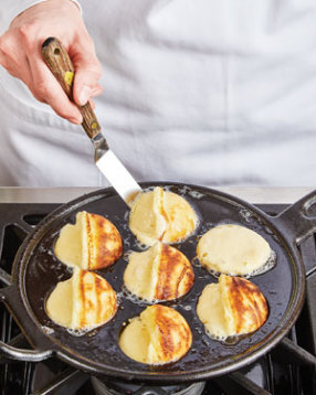 Fry aebleskiver until crusts form, about 2 minutes, before rotating one-quarter turn.