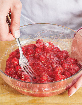 By allowing the raspberries to macerate (or soak) in sugar and lemon juice, helps the raspberries release more of their natural juices.
