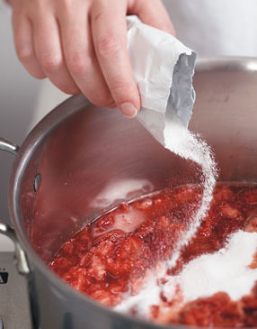 Bring strawberries and powdered fruit pectin to a full rolling bowl. The pectin acts as a gelling agent to thicken jam. 