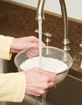 Rinsing the rice with cold water washes off excess starch, which helps the grains cook up fluffy.