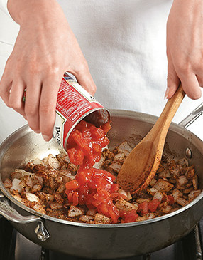 Add canned tomatoes to the onion mixture. Bring to a boil and reduce liquid from tomatoes.
