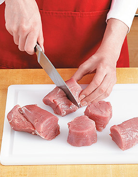 For perfectly sized medallions, slice off the ends of the tenderloin, then cut four medallions from the center.