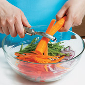 Use a vegetable peeler to cut long, thin carrot strips. Combine carrot strips with snow peas, bean sprouts, bell pepper, and onion for the slaw.