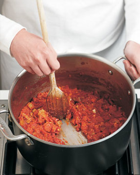 Even drained tomatoes can release a lot of liquid as they cook. Simmer until most of their juice evaporates.