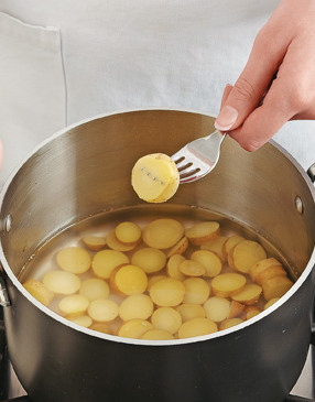 Cook potatoes until fork-tender, then saut&eacute; until slightly browned. They'll finish cooking in the frittata.