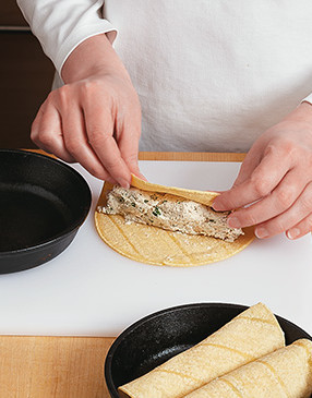 Roll tortilla firmly around filling and place in the pan, seam side down, so they hold together.