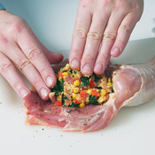 To stuff the boned chicken legs, mound 1/3 cup stuffing into the cavity. Then wrap the meat to enclose the stuffing.
