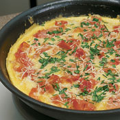 Layer the artichokes, prosciutto, Parmesan, and chives over the eggs. Bake frittata in oven 7&ndash;8 minutes. The center will not be set. 