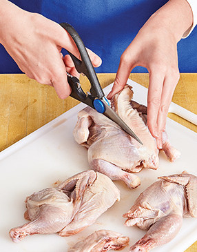 To remove the backbone from the game hens, use kitchen shears to cut along each side of it.