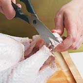 Cut through the skin to the bone around the end of the drumstick, then clip the tendons with shears.