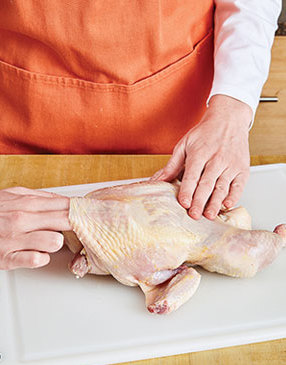 To prevent the spiced butter from leaking out, separate the skin from the chicken without creating holes. 