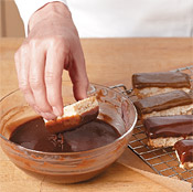 Once the caramel layer is firm, cut the shortbread bars to size and dip the tops into creamy chocolate.