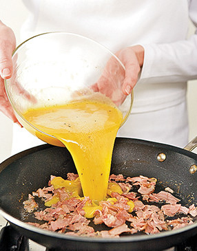 Sauté ham in butter, then add whisked eggs. Let eggs set 1 minute before scrambling.