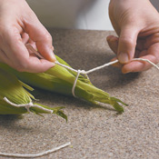 Gather and tie the husks back into place using a simple knot.