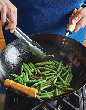 When blistering green beans, make sure that the oil and wok are hot enough before adding the beans. Then keep an eye on them, turning with tongs as they begin to blister.