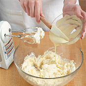 Add melted white chocolate to the beaten cream cheese and butter mixture. Beat to combine.