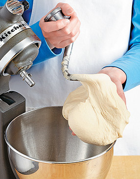 Use a stand mixer to combine and knead the dough. It's ready when it begins to climb up the dough hook.