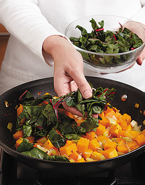 Add Swiss chard ribbons to the cooked squash. Sweat, covered, until softened but not mushy.