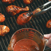 Partially grill chicken legs, then dip them into the sauce. Return chicken legs to the grill. 