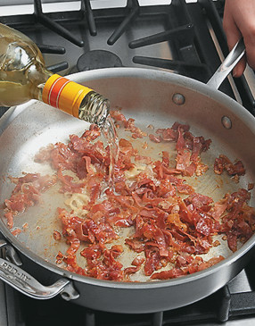 Deglaze the pan with white wine, scraping up all the brown bits from the bottom of the pan.