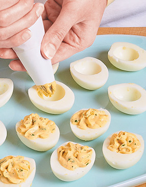 For great presentation and to easily fill the egg halves, use a piping bag to pipe the yolk mixture.