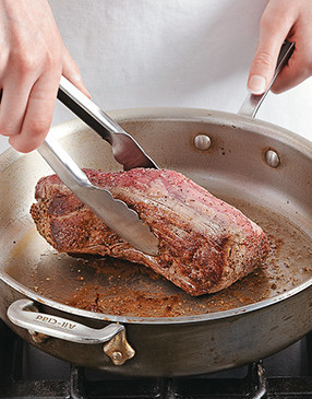 To create a deep brown crust that’s key to the meat’s flavor and texture, sear the tenderloin on all sides.