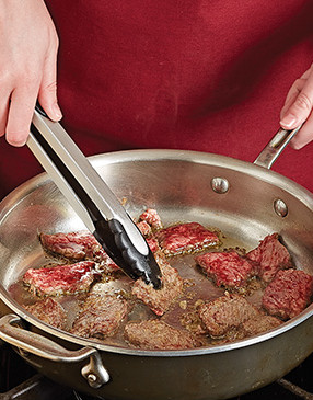 For good browning and flavor, dredge the steak in flour, then sauté it over relatively high heat.