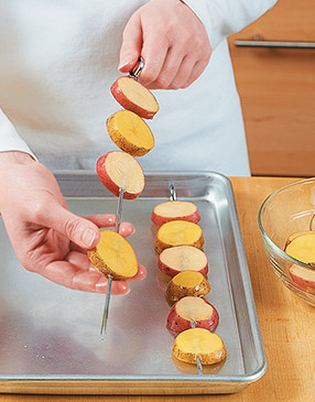Cut potatoes thick enough for easy skewering, then thread so they lay flat for direct contact with the grill.