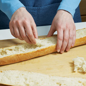 Create a well for the salad by removing as much of the middle of the baguette halves as possible.