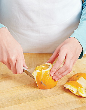 To section an orange, slice off the ends, cut along the curve, then slice on either side of each membrane.