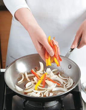 After browning the sausage, use the same hot skillet to sauté onion and peppers so they pick up the flavor.