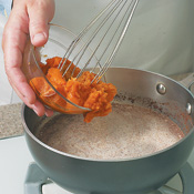 Pumpkin, maple syrup, and spices are heated with the cream and half-and-half, then whisked into the eggs.