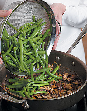 Add blanched beans to mushroom mixture. They're already cooked, so just heat them through.