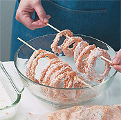 Lay skewers with onion rings over a bowl to drip while you dip the rest of the onions.
