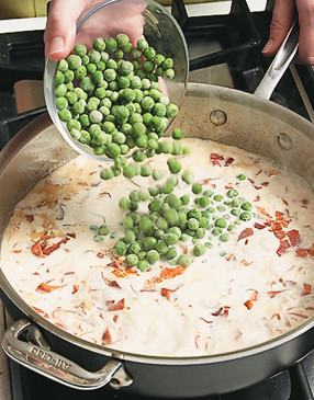 Add the cream, peas, and cooked pasta. It's OK if the peas are frozen, they'll thaw in the sauce.