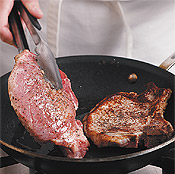 Sear chops until they're browned, about 5 minutes on each side; set chops aside on a plate.