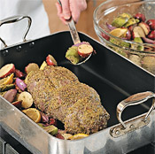 Toss vegetables with reserved paste and add to the roasting pan after lamb has cooked 20 minutes.