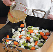 Adding broth to the vegetables keeps the turkey moist and adds flavor to the juices for the gravy.
