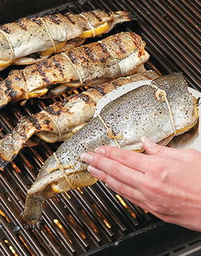 Use a large spatula to carefully flip each trout. Oiling them before grilling ensures they’ll release easily.