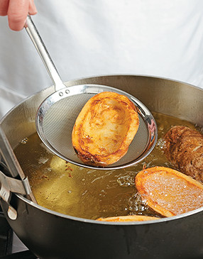Deep-frying the potato skins until golden brown makes the base for these potatoes crunchy and sturdy.