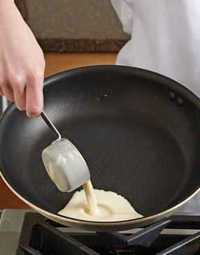 Once skillet is HOT and brushed with melted butter, pour the batter to the side using a &frac14; cup measure.