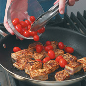 Add tomatoes to the seared tuna and saut&eacute; just until the skins begin to blister.