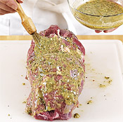 Coat the inside of the lamb with the paste, role and tie it, then coat the outside with more paste.