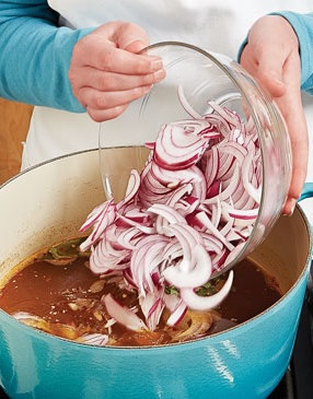 Simmer the chicken broth with plenty of red onion, garlic, and spices to infuse it with flavor.