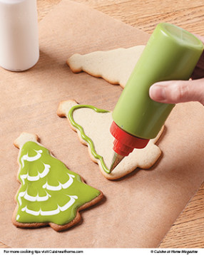 Pipe a border of darker green icing around edges of cookie with a decorating squeeze bottle or disposable decorating bag.