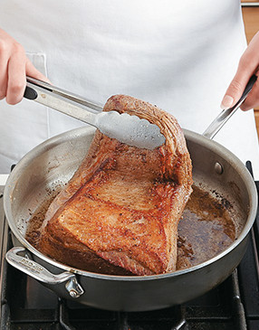 For the best browning and flavor, leave the fat cap on the brisket while searing and braising.