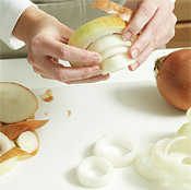 Slice ends off the onion, cut into 1-inch-thick slices, and separate into rings, pushing through the center.