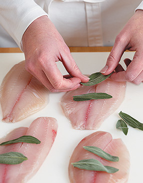 Place fresh sage over fillets. The sage will impart its flavor to the fish when heated on the grill.